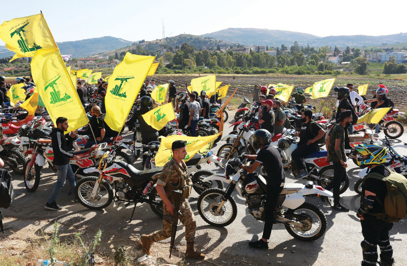  SUPPORTERS OF Hezbollah leader Hassan Nasrallah gather in a convoy of motorbikes marking ‘Resistance and Liberation Day’, near the Lebanese border with Israel, in May.  (photo credit: AZIZ TAHER/REUTERS)