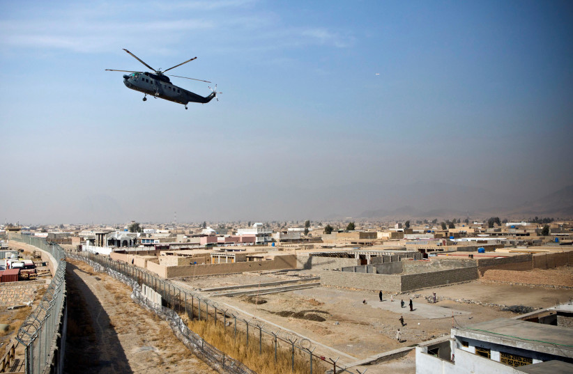  A military helicopter lands at Camp Nathan Smith in Kandahar City, Kandahar Province, Afghanistan, January 16, 2013. (credit: ANDREW BURTON/REUTERS)