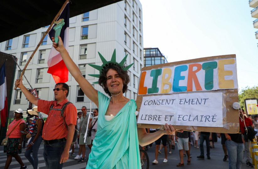  A protester dressed as the Statue of Liberty holds a placard reading ''Liberty, free and informed consent'' during a demonstration called by the French nationalist party ''Les Patriotes'' (The Patriots) against France's restrictions, including a compulsory health pass, to fight the coronavirus disease  (credit: REUTERS/SARAH MEYSSONNIER)