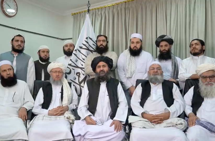  Mullah Baradar Akhund, a senior official of the Taliban, seated with a group of men, makes a video statement, in this still image taken from a video recorded in an unidentified location and released on August 16, 2021 (credit: SOCIAL MEDIA/REUTERS)
