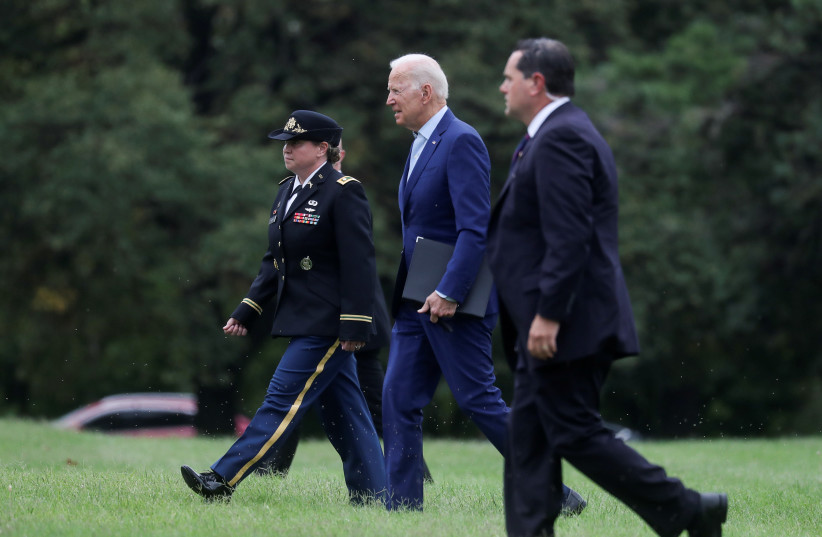 US President Joe Biden walks from Marine One in the falling rain as he arrives at Fort McNair on his way back to the White House to deliver a statement on Afghanistan, in Washington, U.S., August 16, 2021. (photo credit: LEAH MILLIS/REUTERS)