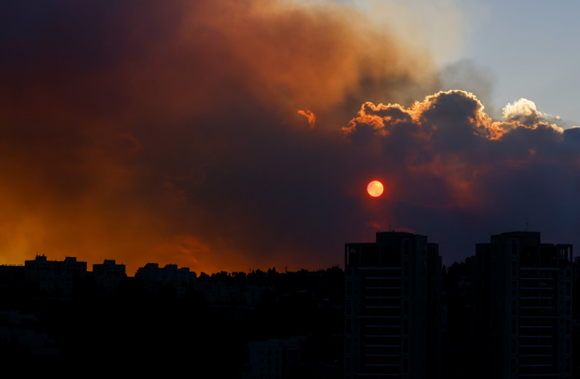  The sky over Jerusalem painted red and filled with smoke following a massive forest fire raging out in a forest near Beit Meir, outside of Jerusalem on August 15, 2021. (photo credit: OLIVIER FITOUSSI/FLASH90)