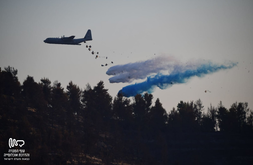 IAF Samson (Hercules) plane dropping extinguishing material over flames in Jerusalem fire, August 17, 2021 (credit: KOBI RICHTER/ FIRE AND RESCUE)