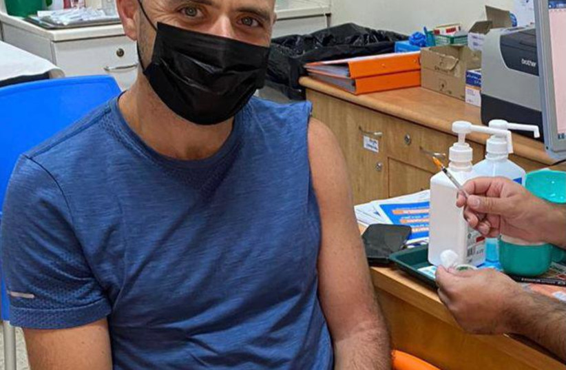  Lior Meir Sion, 44-years-old, received his third vaccine on Thursday evening after the government announced that anyone aged 40+ would be eligible. (credit: MEUHEDET)