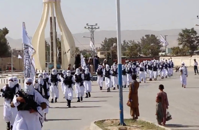 Taliban fighters march in uniforms on the street in Qalat, Zabul Province, Afghanistan, in this still image taken from social media video uploaded August 19, 2021  (credit: REUTERS)