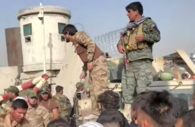  Afghanistan Special Forces try to keep a crowd from entering, outside Kabul Airport, Afghanistan, August 18, 2021 in this still image obtained from a social media video obtained by REUTERS. (credit: REUTERS)