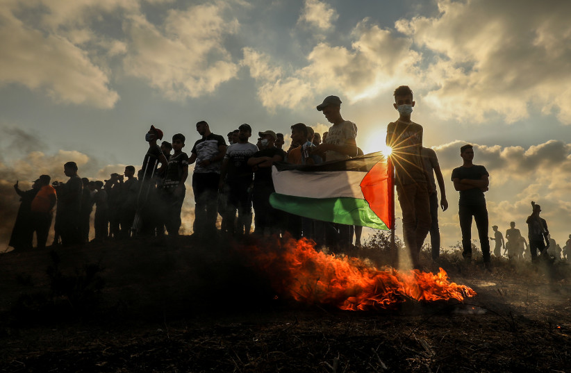  Palestinian protesters clash with Israeli forces during a protest at the Israel-Gaza border, east of Gaza City, on August 21, 2021.  (credit: ABED RAHIM KHATIB/FLASH90)
