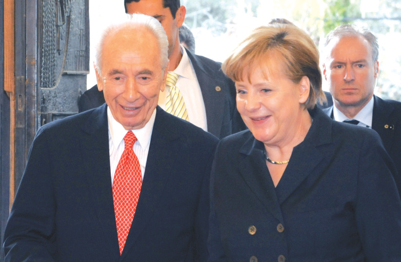  FORMER PRESIDENT Shimon Peres meets with German Chancellor Angela Merkel at his official residence in Jerusalem in 2011. (credit: MARK NEYMAN/GPO)