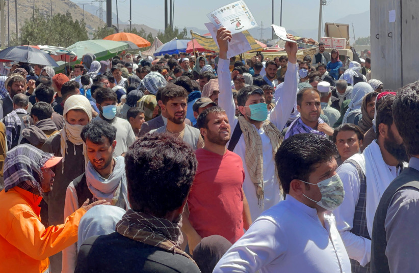  Crowds of people show their documents to U.S. troops outside the airport in Kabul, Afghanistan August 26, 2021 (photo credit: REUTERS/STRINGER)