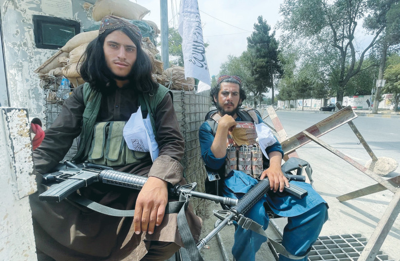  MEMBERS OF TALIBAN forces sit at a checkpoint in Kabul earlier this month. (credit: REUTERS)