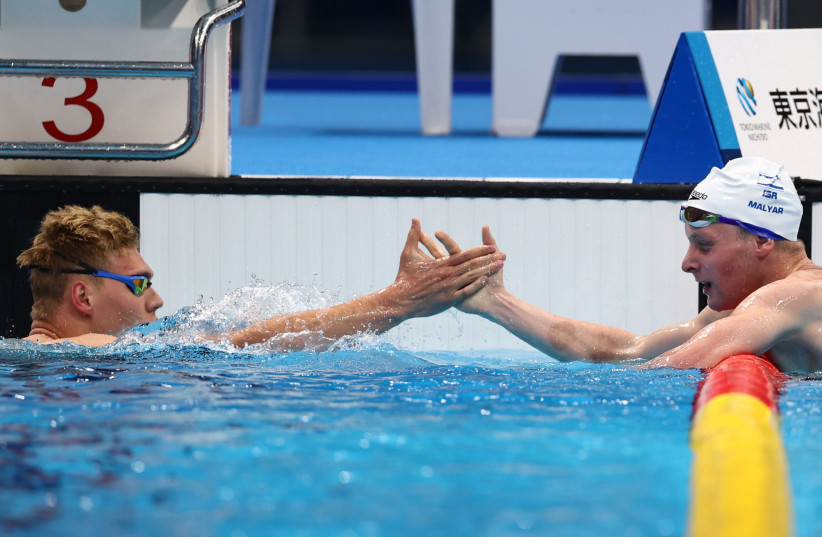  Tokyo 2020 Paralympic Games - Swimming - Men's 200m Individual Medley - SM7 Final – Tokyo Aquatics Centre, Tokyo, Japan - August 27, 2021. Mark Malyar of Israel celebrates after winning gold with Andrii Trusov of Ukraine. (credit: MARKO DJURICA/REUTERS)