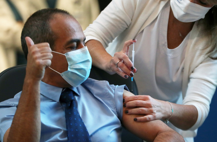  RONNI GAMZU, head of Tel Aviv’s Sourasky Medical Center and former coronavirus ‘czar,’ is vaccinated against the disease as Israel kicked off a vaccination drive last year. (credit: RONEN ZVULUN / REUTERS)