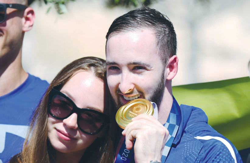  ARTIUM DOLGOPYAT, Gold Medal winner in the Olympic games in Tokyo, with his fiancée during a welcome ceremony at Ben-Gurion Airport, near Tel Aviv, earlier this month.  (credit: TOMER NEUBERG/FLASH90)