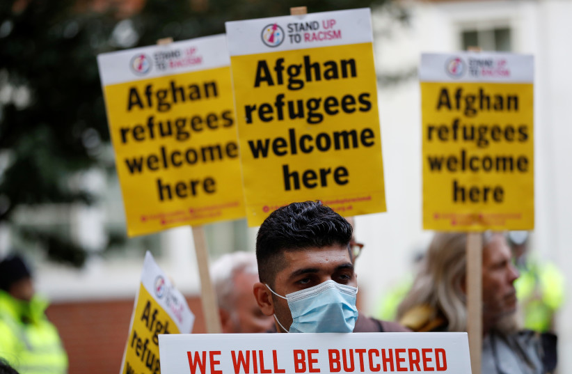  Demonstrators take part in a protest, called jointly by Stand Up To Racism and the Afghan Human Rights Foundation, in support of refugees from Afghanistan, in London, Britain August 23, 2021. (photo credit: REUTERS/PETER NICHOLLS)