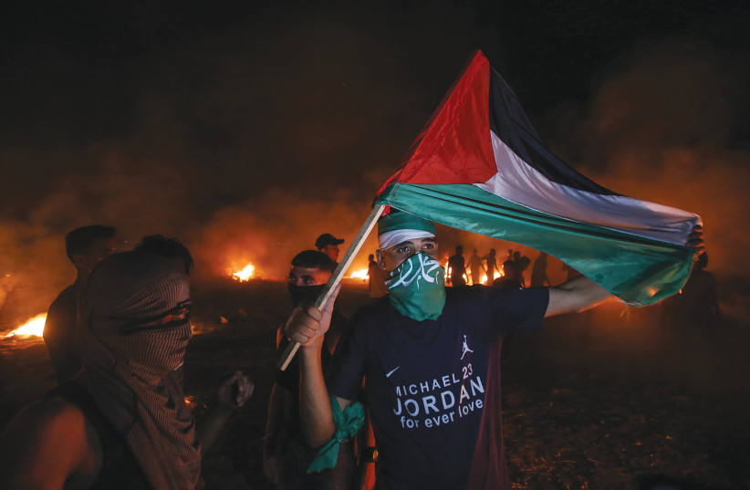  PALESTINIANS PROTEST near the border fence with Israel east of Gaza City. (credit: ATIA MOHAMMED/FLASH90)