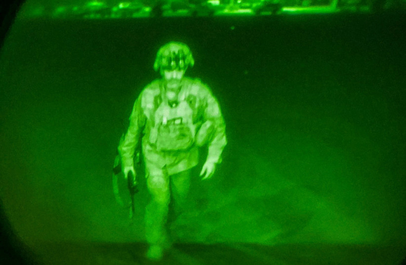  US Army Major General Chris Donahue, commander of the 82nd Airborne Division, steps on board a C-17 transport plane as the last US service member to leave Hamid Karzai International Airport in Kabul, Afghanistan August 30, 2021 in a photograph taken using night vision optics.  (credit: XVIII Airborne Corps/Handout via REUTERS)