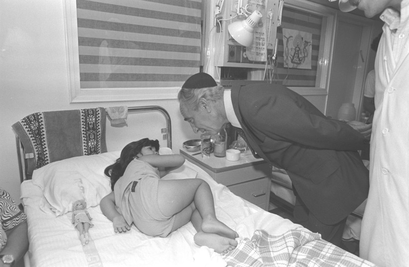  SHIMON PERES, then prime minister, visits a sick girl at the Laniado Hospital in Netanya in 1985.  (credit: NATI HARNIK/GPO)