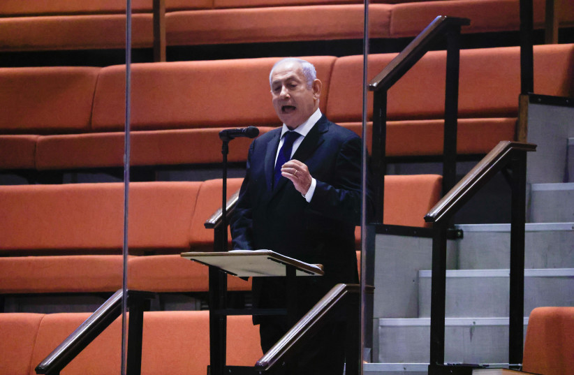  Former Israeli prime minister Benjamin Netanyahu addresses the Israeli parliament from the guest bleachers of the plenum hall during a plenum session on the state budget. Netanyahu is currently in quarantine, and was only able to participate from a distance, on the guest bleachers. September 2, 2021 (credit: OLIVER FITOUSSI/FLASH90)