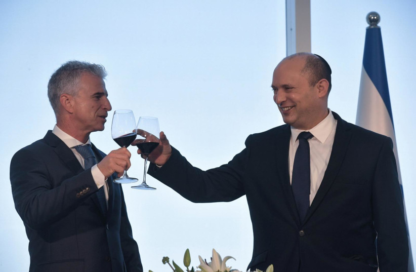  PM Naftali Bennett and Mossad head David Barnea toast ahead of Rosh Hashana on September 1, 2021. (photo credit: KOBI GIDEON/GPO)