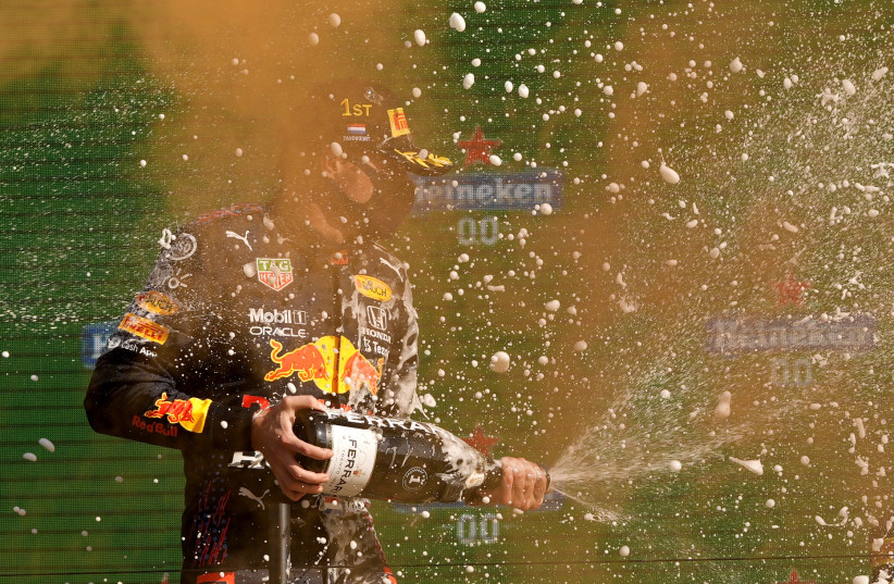  Formula One F1 - Dutch Grand Prix - Circuit Zandvoort, Zandvoort, Netherlands - September 5, 2021 Red Bull's Max Verstappen celebrates on the podium with champagne after winning the race.  (credit: POOL VIA REUTERS/FRANCISCO SECO)