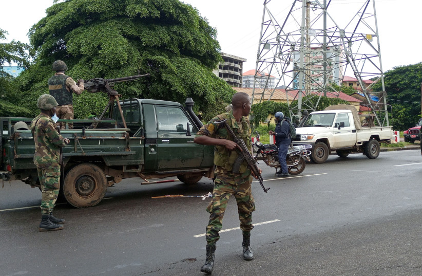 Army soldiers hold a checkpoint after the uprising that led to the toppling of President Alpha Conde in Kaloum neighbourhood of Conacry in Guinea, September 6, 2021. (credit: REUTERS/SOULEYMANE CAMARA)