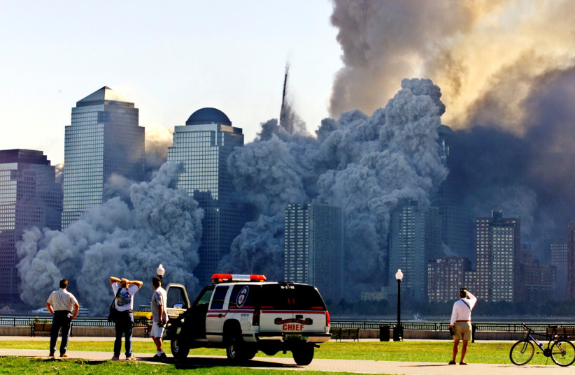  THE WTC’S Tower 2 dissolves in a  cloud of dust and debris about 30  minutes after the first Twin Tower  collapsed, as seen from Jersey City,  September 11, 2001. ( (credit: REUTERS/RAY STUBBLEBINE)