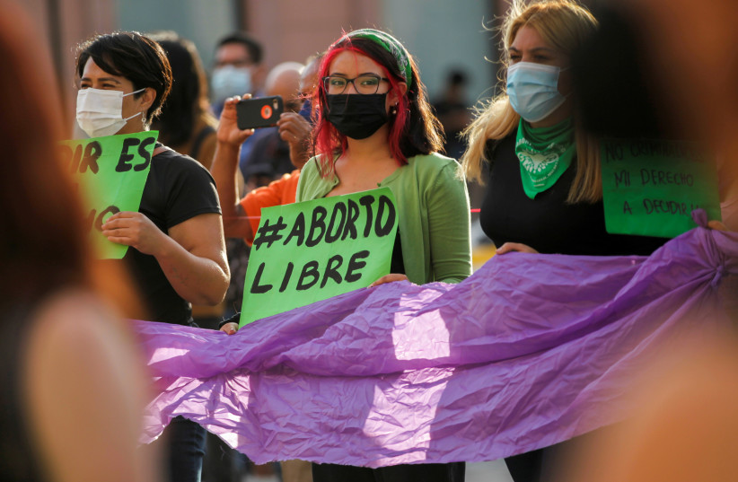  A woman holds a banner which reads ''Free abort'' during a protest to celebrate the decision of the Supreme Court of Justice of the Nation (SCJN) that declared the criminalization of abortion as unconstitutional, in Saltillo, Mexico. (credit: DANIEL BECERRIL/REUTERS)