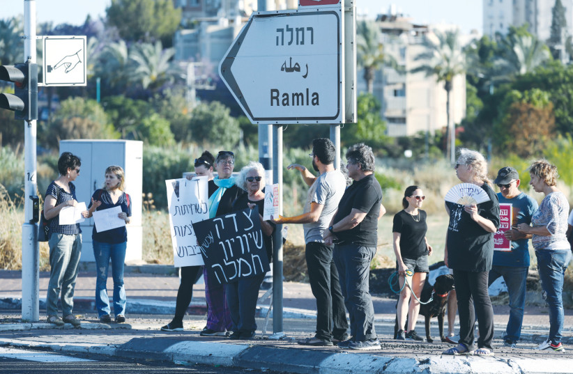  JEWS AND MUSLIMS protest together for calm and coexistence in Lod, following a night of heavy rioting by Arab residents in the city, in May. (credit: YOSSI ALONI/FLASH90)