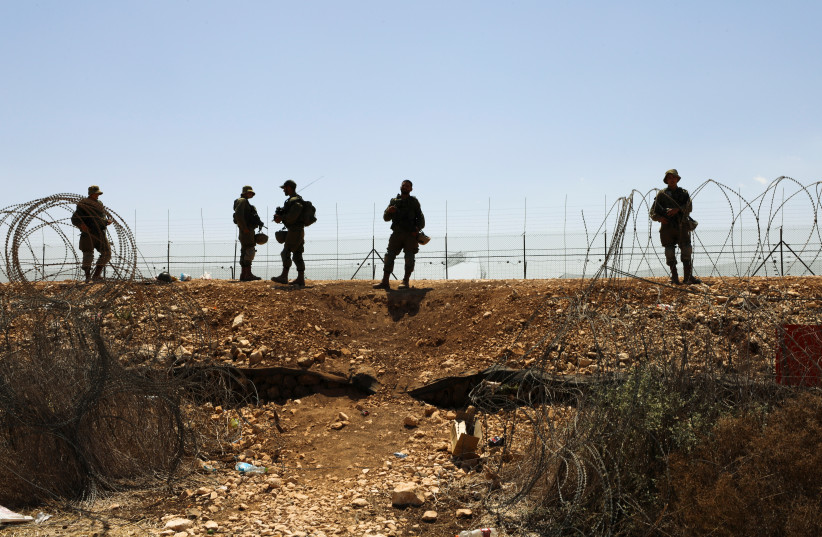  Israeli soldiers guard along a fence leading to the West Bank, as part of search efforts to capture six Palestinian men who had escaped from Gilboa prison earlier this week, September 9, 2021. (credit: REUTERS/AMMAR AWAD)