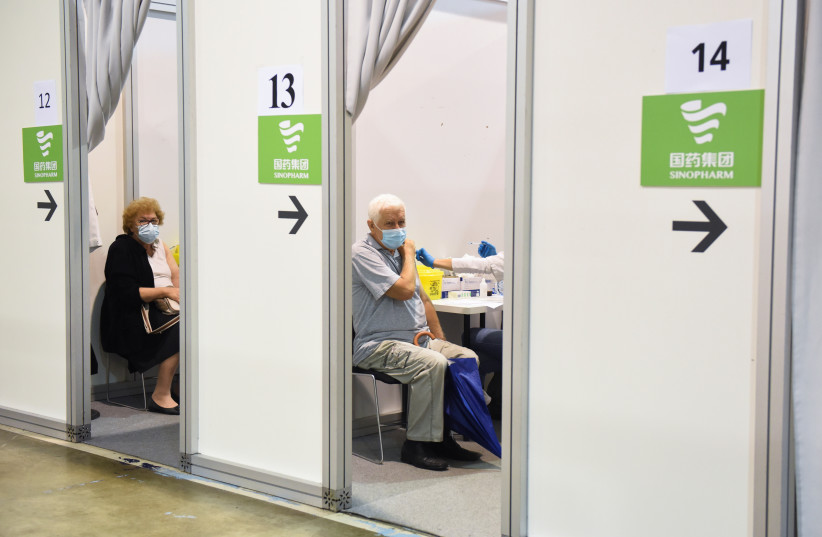  People receive a third dose of the Sinopharm vaccine against the coronavirus disease (COVID-19) at the Belgrade Fair vaccination center in Belgrade, Serbia, August 25, 2021. (credit:  REUTERS/ZORANA JEVTIC)