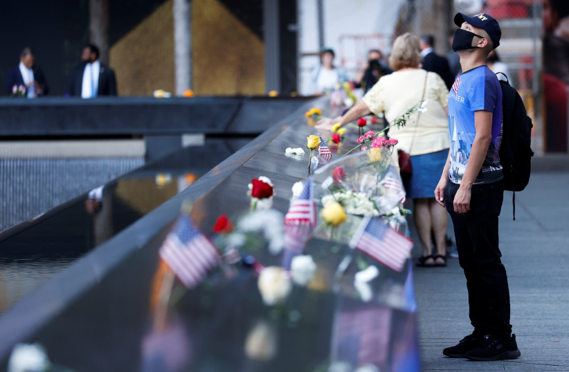  People visit the 9/11 Memorial on the 20th anniversary of the September 11 attacks in Manhattan, New York City, US, September 11, 2021 (credit: REUTERS/MIKE SEGAR)