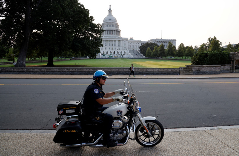US Capitol Police officer patrols around the US Capitol in Washington, DC (photo credit: REUTERS)