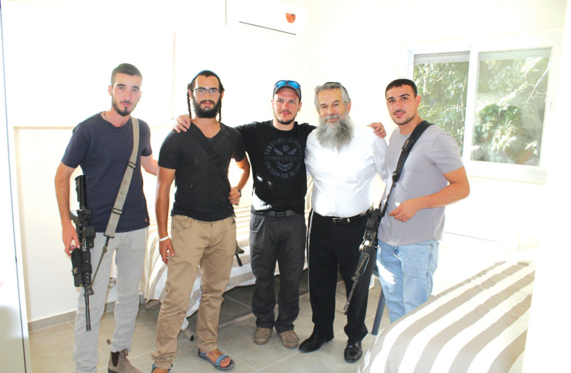  JERUSALEM APARTMENT. Rabbi Myers with IDF troops in a combat unit in a renovated  and fully-furnished Emek Lone Soldiers’ apartment in Jerusalem’s German Colony. (credit: Courtesy)