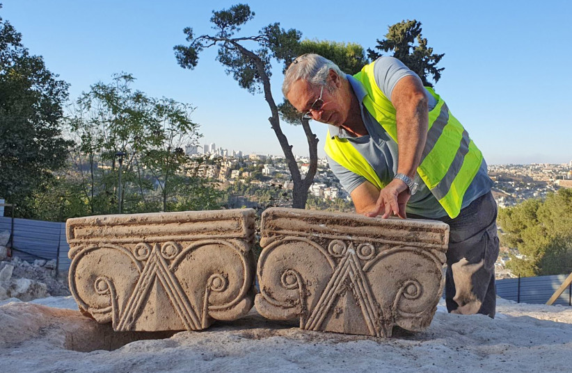  EXCAVATION DIRECTOR Yaakov Billig with the capitals found in Arnona, Jerusalem.  (credit: YOLI SCHWARTZ/IAA)