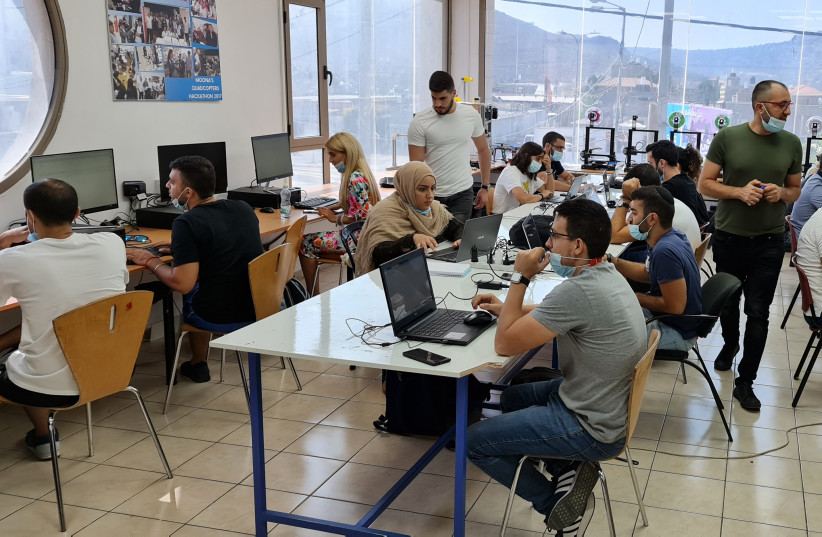  ISRAELI-ARAB and Jewish engineers work together at Moona’s center in the northern Arab town of Majd al-Krum.   (photo credit: FADI HASHEM)
