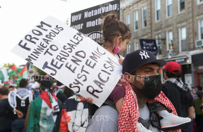 A placard at a pro-Palestinian rally in New York in May demonstrates the Left’s understanding that racism in the US is comparable to what Palestinians contend with in Israel. (credit: REUTERS)