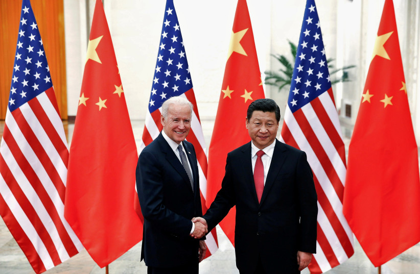  Chinese President Xi Jinping shakes hands with then-U.S. Vice President Joe Biden (L) inside the Great Hall of the People in Beijing December 4, 2013. (photo credit: REUTERS/LINTAO ZHANG/POOL)