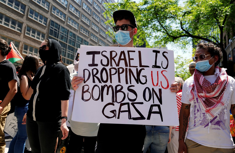  Pro-Palestinian supporters demonstrate across the street from the Israeli Consulate in New York City (photo credit: REUTERS/CARLO ALLEGRI)