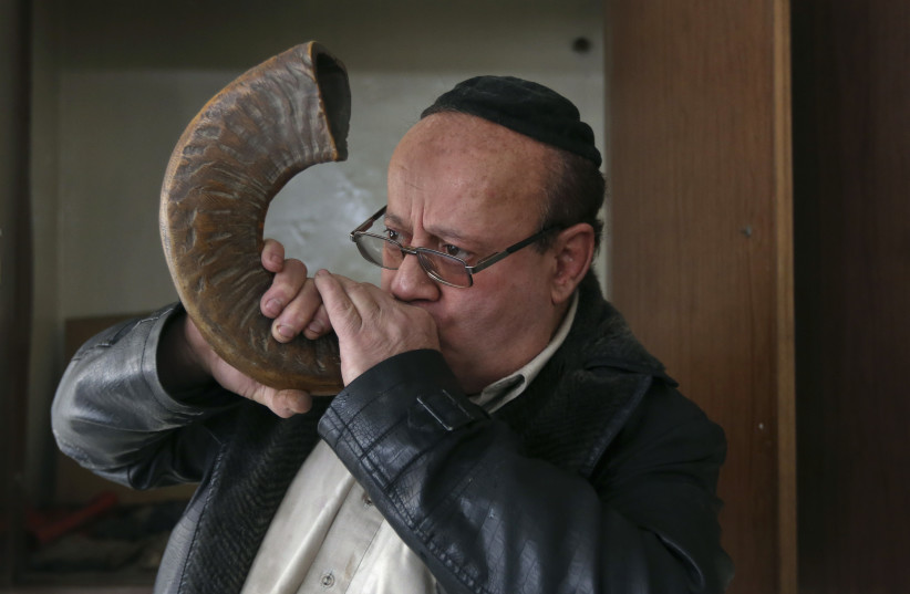  Zabulon Simantov, an Afghan Jew, blows the traditional shofar, or ram's horn, at a synagogue in Kabul (credit: REUTERS/OMAR SOBHANI)