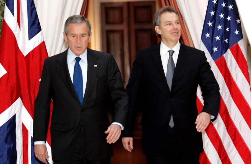  U.S. President George W. Bush (L) and British Prime Minister Tony Blair walk together from their meeting at the U.S. Embassy in Brussels, February 22, 2005.  (credit: REUTERS/KEVIN LAMARQUE/FILE PHOTO)