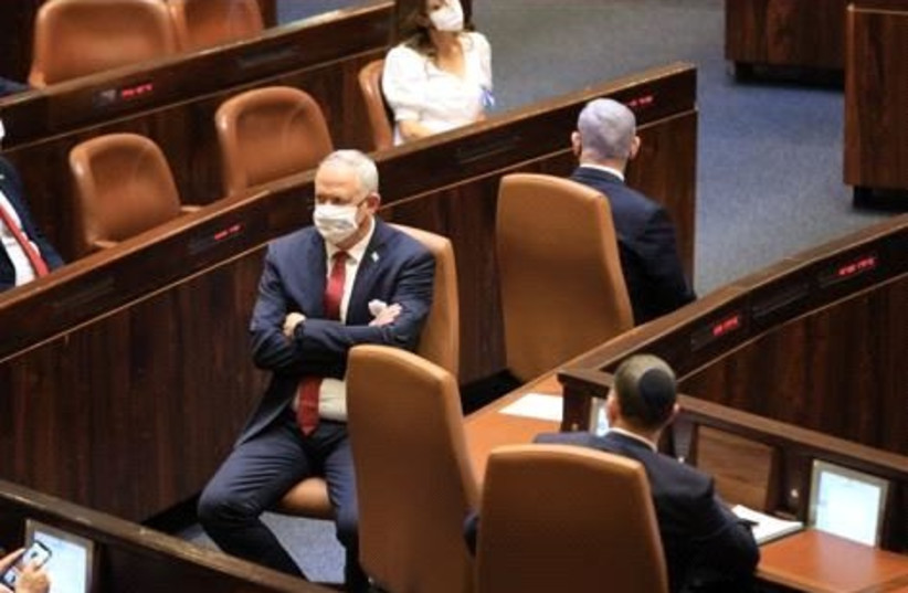  Benny Gantz and Benjamin Netanyahu sitting opposite one another in 24 Knesset Swearing in Ceremony. (credit: KNESSET)