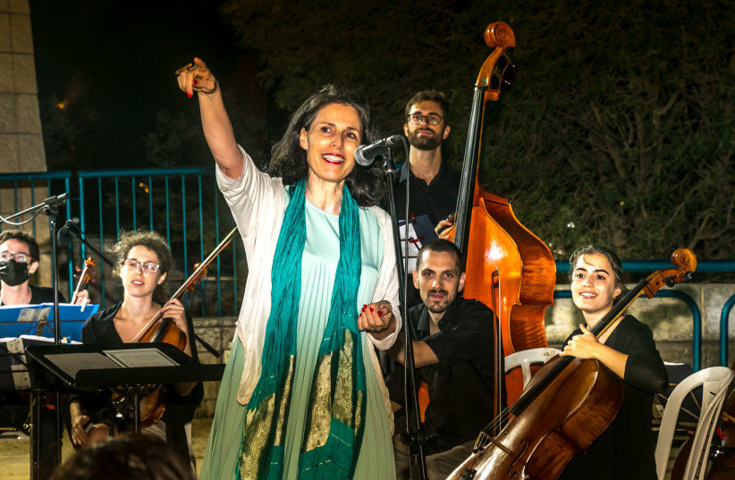  RUTH DISKIN of the Jerusalem Foundation addresses Jerusalem Street Orchestra concert attendees at the Armon Hanatziv Community Center.  (credit: SASSON TIRAM)