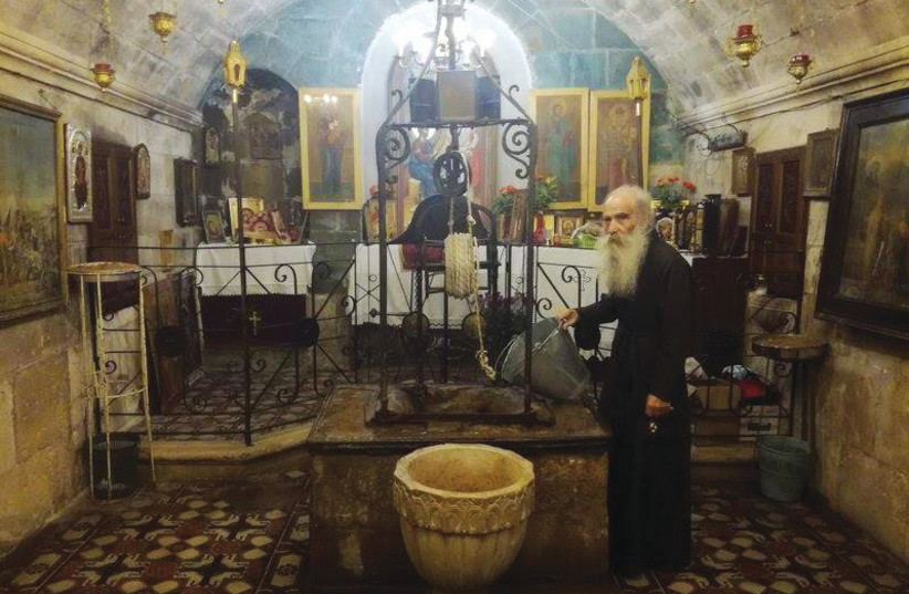  ARCHIMANDRITE IOUSTINOS spent six months painting the church’s dome, which depicts Jesus surrounded by his 12 disciples. (credit: GIL ZOHAR)