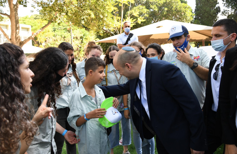  Prime Minister Naftali Bennett in Krembo Wings' Sukkah on September 22, 2021. (credit: CHAIM TZACH/GPO)
