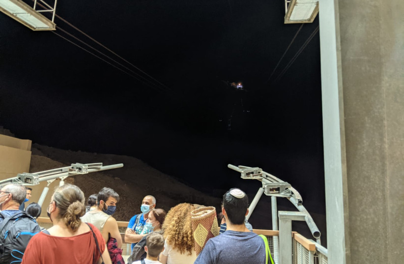 VISITORS TO the Tamar Festival sunrise show await the cable car to climb to the top of Masada, September 2021 (credit: HADAS LABRISCH)