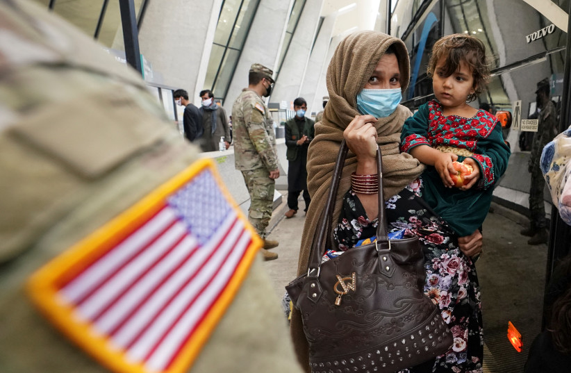  A day after U.S. forces completed its troop withdrawal from Afghanistan, refugees board a bus taking them to a processing center upon their arrival at Dulles International Airport in Dulles, Virginia, US, September 1, 2021.  (credit: REUTERS/KEVIN LAMARQUE)