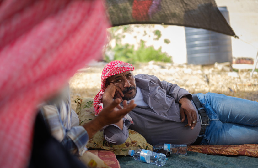  Members of the Jahalin Bedouin Tribe sit in a tent in Khan al-Ahmar (credit: YANIV NADAV/FLASH90)