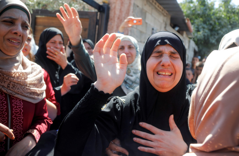  Mother of Palestinian Osama Soboh, who was killed during clashes with IDF troops, mourns during his funeral in Burqin September 26, 2021.  (credit: REUTERS/RANEEN SAWAFTA)