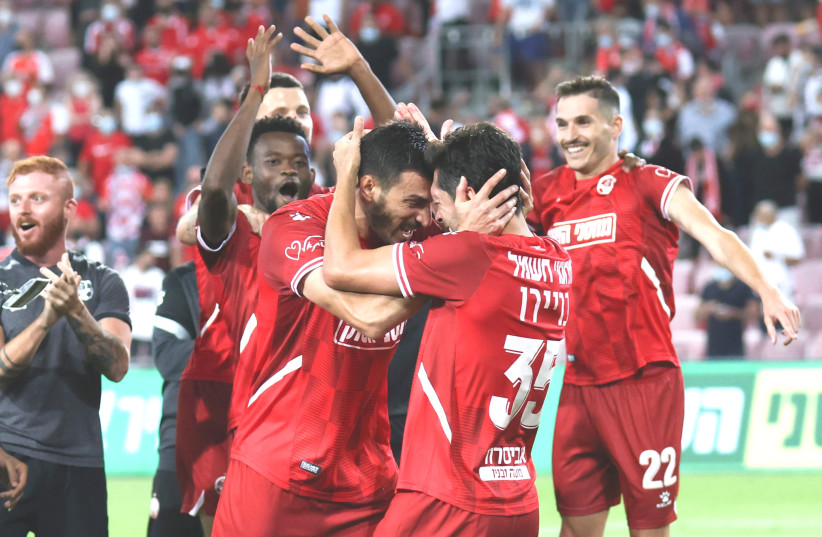  HAPOEL BEERSHEBA teammates celebrate after scoring their second tally in Saturday night's 2-0 home victory over Maccabi Tel Aviv in Premier League action down south. (photo credit: DANNY MARON)