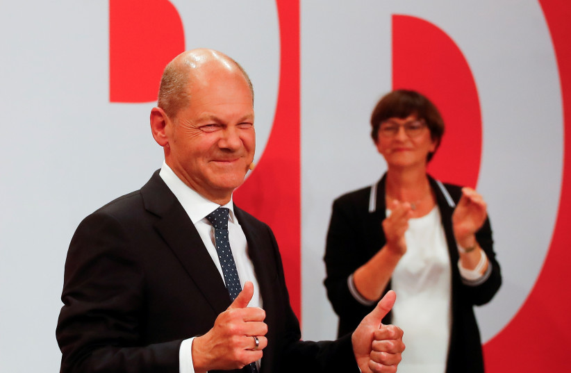  Social Democratic Party (SPD) leader and top candidate for chancellor Olaf Scholz and party co-leader Saskia Esken react after first exit polls for the general elections in Berlin, Germany (photo credit: WOLFGANG RATTAY / REUTERS)